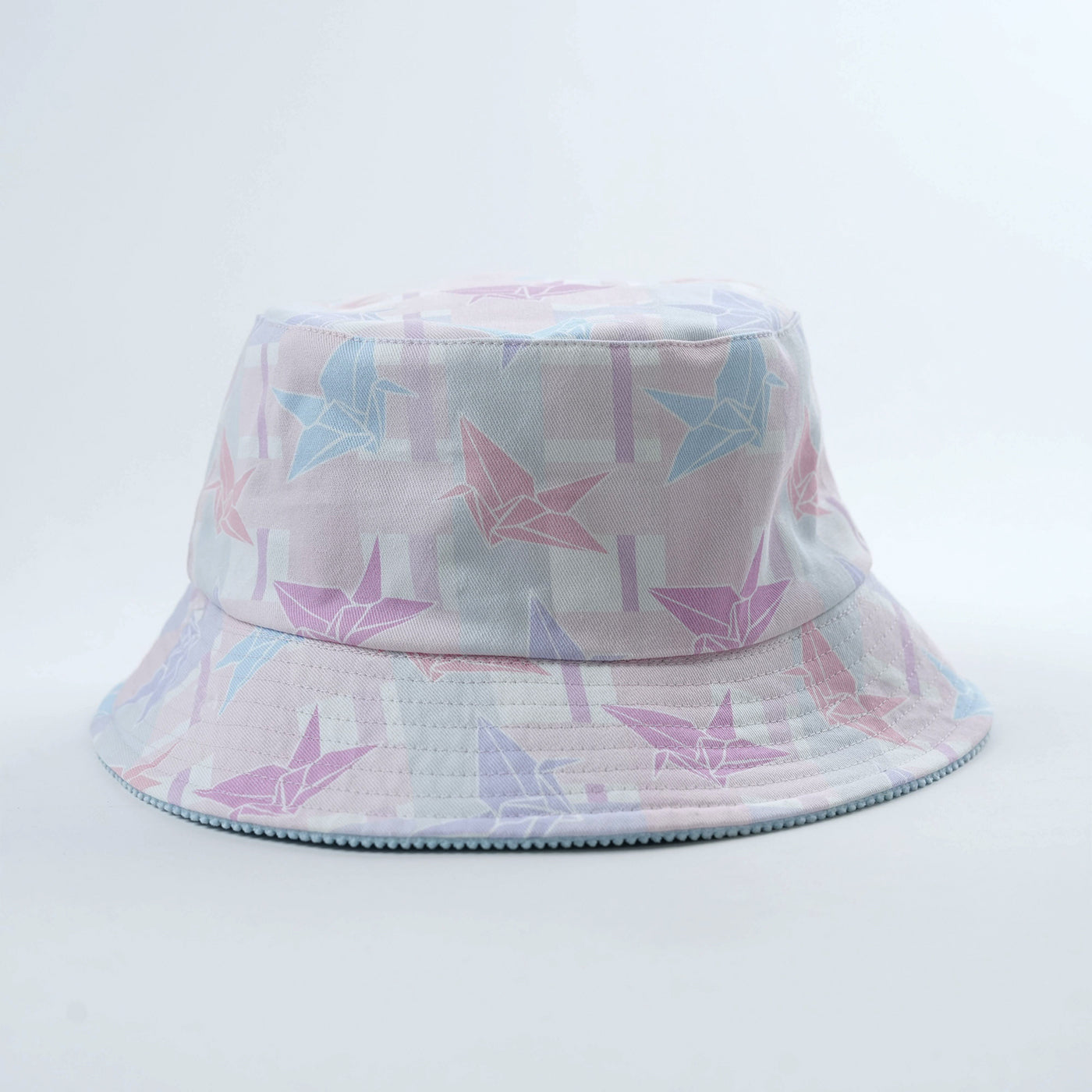Bucket hat with tartan origami design on a light gray background