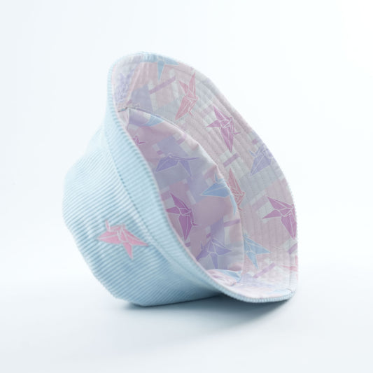 Light blue bucket hat with pink embroidery, purple and blue origami crane pattern on reversible side in cotton